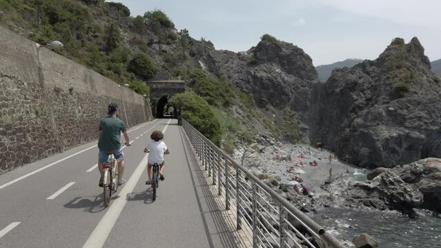Italy , Liguria , June 2022 - Going bike from  Levanto Bonassola Framura cycle  pedestrian path - old galleries tunnels  in the rock by the sea - tourist attraction in the Cinque Terre