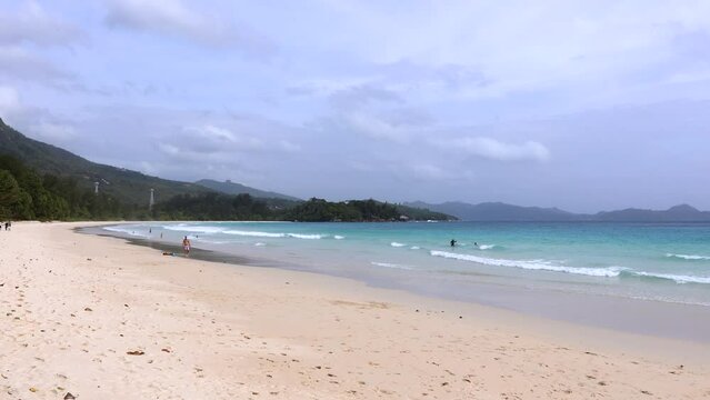 Paradise beach with people in the Seychelles