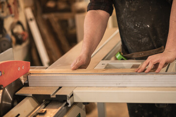 Cropped of businessman carpenter hands working with wood timber, measuring, preparing to cut....