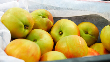 Close-up of a heap of beautiful ripe nectarines in a trading box