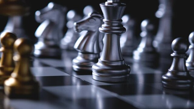 silver and gold chess are facing each other, business management ideas strategize to conquer opponents.