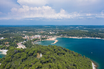 Aerial view of beach and resorts on the coast of Rovinj with green blue clear water on the Adriatic sea