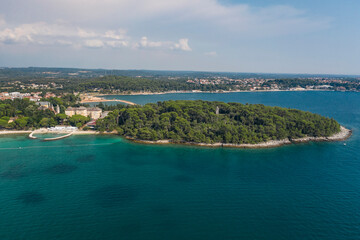 Aerial view of the a beach in Rovinj with a forest on the Adriatic sea in Croatia