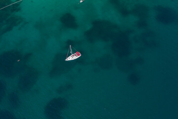 Aerial of sailing boat with beautiful blue sea water in greece