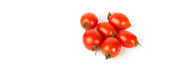 Red cherry tomatoes on white background, empty space for text. Selective focus.