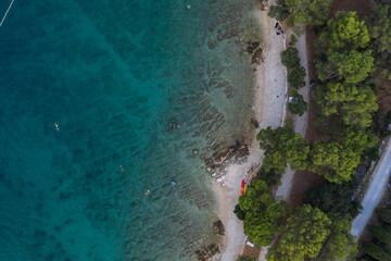 Aerial top view of a beach with turquoise blue green sea water of the adriatic sea, Rovinj, Croatia 
