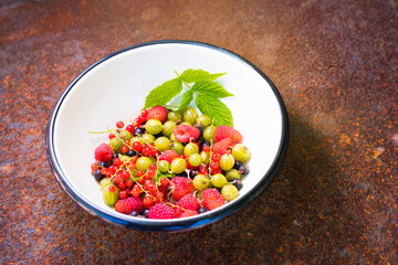 raspberries, currants, gooseberries, fresh fruits on background