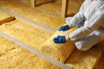 Construction worker thermally insulating house