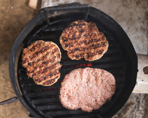 grilling burgers on flaming grill