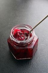 Wild rose petal jam in a glass jar . Homemade simple delicious dessert  made with wild rose petals,...