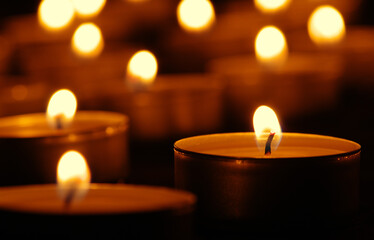 Many burning candles with bokeh light background