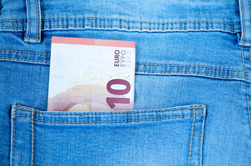 money ten euro bill in a blue jeans pocket