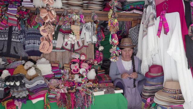 Traditional woman (cholita) weaving in the Recoleta market, Sucre
