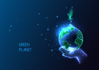 Concept of environmental social responsibility with hand holding Earth globe and sprout on dark blue - obrazy, fototapety, plakaty