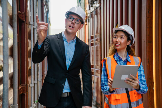 Manager and contenner worker working in the construction container yard