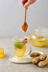Ginger and fruit tea with honey glass cup pouring