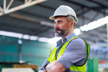 Portrait Caucasian professional Engineer factory. Engineering worker in safety hardhat at factory...