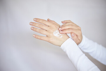 protection of the skin of the hands in the cold season. Close-up of a woman applying cream to her
