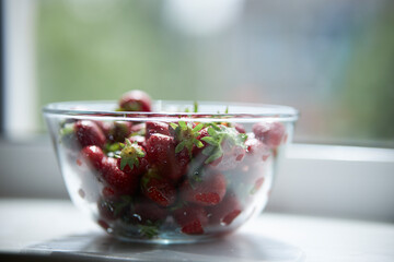 Strawberries in a glass plate close-up. Seasonal berry. 