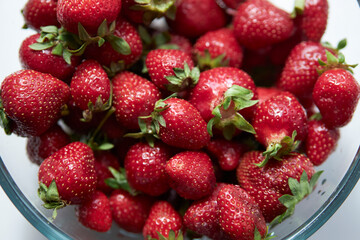 Strawberries in a glass plate close-up. Seasonal berry. 
