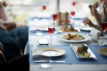 The table is set. Red wine in glasses on the table. Festive table setting  