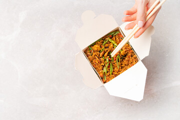 Wok box with asian rice fast food. Background with copy space.