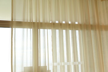 Thin white curtains (light cream) are used for light sun protection or to block light from entering...