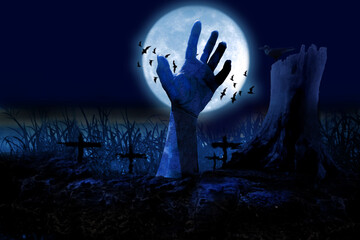  Zombie hands rising in dark Halloween night.