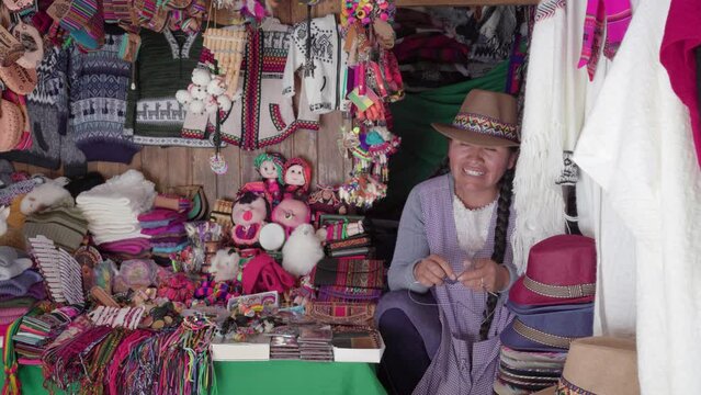 Traditional woman (cholita) weaving in the Recoleta market, Sucre