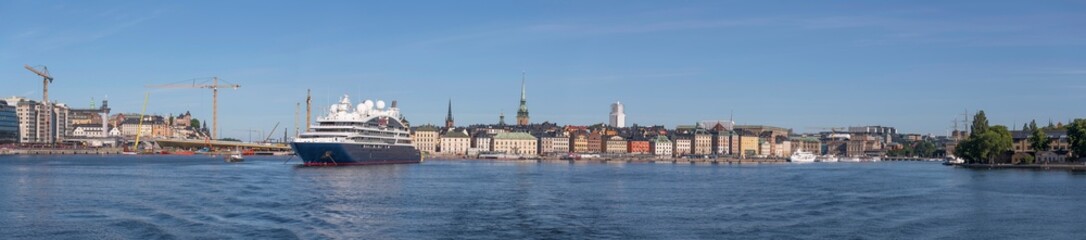 Cruise ship moored in the bay Saltsjön, the old town Gamla Stan and the Sluice construction in the...