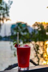 Watermelon fruity smoothy with lake background for traveling