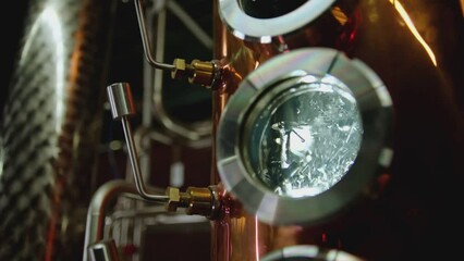 Hot water , liquid boiling inside distillery or filtration tank . Alcohol drink factory or physical experiment laboratory . Cooper or metal machine . Hot temperature , high pressure . Close up