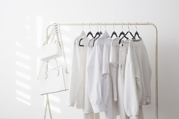 female white capsule summer wardrobe in  white room