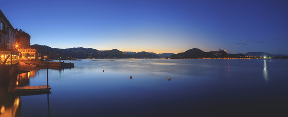 Arona, Italy. Panoramic view from the small town of Arona at dusk after sunset on Lake Maggiore. June 10, 2022.