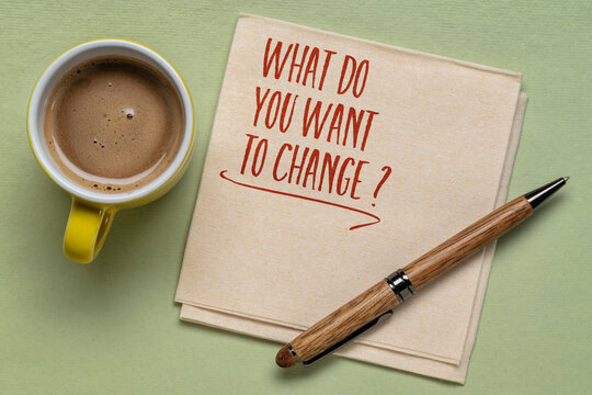 What do you want to change? Handwriting on a napkin with cup of coffee. Business, lifestyle and personal development concept.