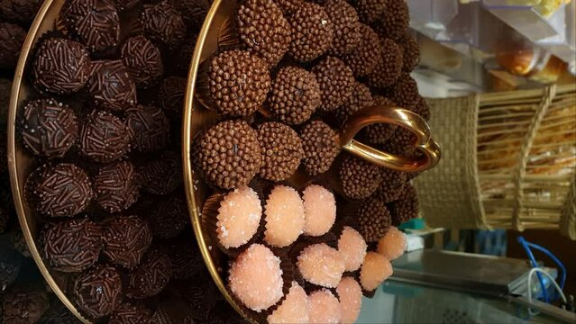 Tower closeup with several brigadiers. Traditional Brigadeiro and bicho de pe_vertical.