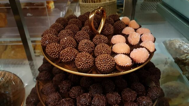 Tower closeup with several brigadiers. Traditional Brigadeiro and bicho de pe.