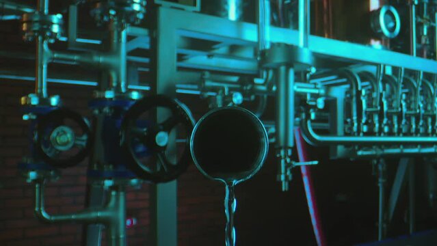 Liquid or water pouring from tube inside chemical laboratory . Chemistry toxic materials . Lab experiments . Camera moving inside pipe . Closeup slow motion . Shot on ARRI ALEXA Camera with Laowa lens