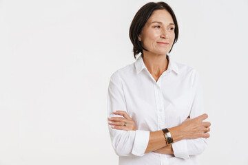 Mature woman smiling while posing with arms crossed