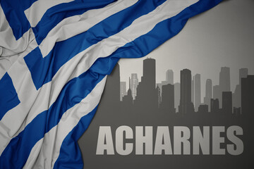 abstract silhouette of the city with text Acharnes near waving national flag of greece on a gray...