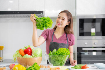 Asian women cooking salad vegetable organic eat healthy  at kitchen home