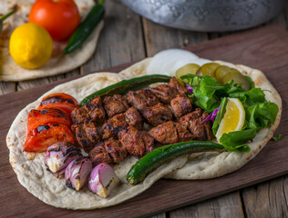 Meat Tikka platter served in a dish side view on wooden table background