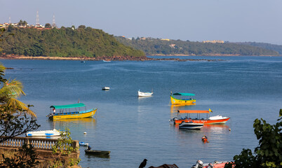 Colorful fishermen boats in Arabian sea near Old Goa in India.