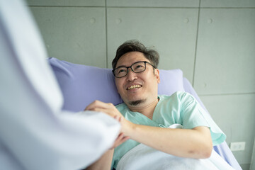 Doctor holding touching hands Asian senior male patient with love, care, helping, encourage and empathy at nursing hospital ward, healthy strong medical concept