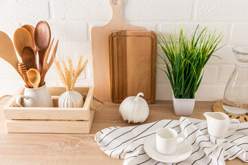 a fragment of the interior of a modern kitchen. various kitchen utensils on a countertop with a houseplant. eco-subjects.