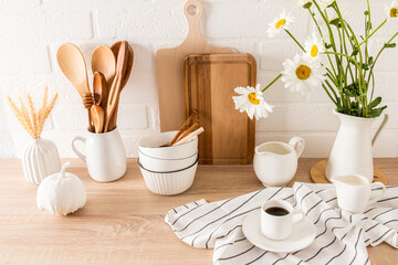 Stylish white kitchen background eco-friendly kitchen with utensils for storing inventory. a cup of morning coffee on the countertop.
