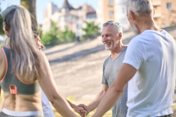 People holding hands and looking happy