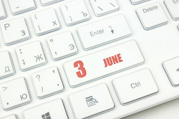 June 3rd. Day 3 of month, Calendar date. Cropped view of Modern White Computer Keyboard with calendar date. Concept workspace, freelance, deadline.  Summer month, day of the year concept.