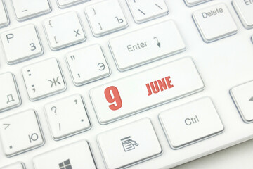 June 9th. Day 9 of month, Calendar date. Cropped view of Modern White Computer Keyboard with...