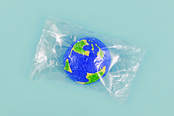 Small planet earth model wrapped in plastic